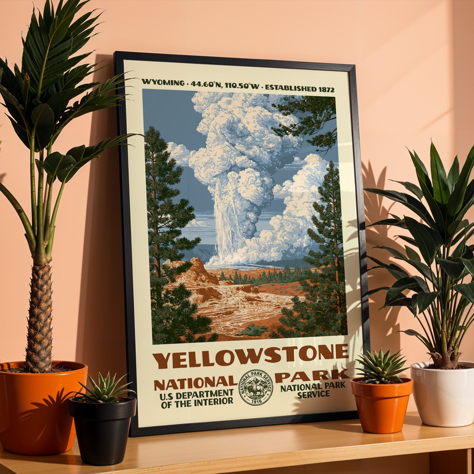 Yellowstone National Park WPA print in a black frame on a shelf against a warm terracotta wall