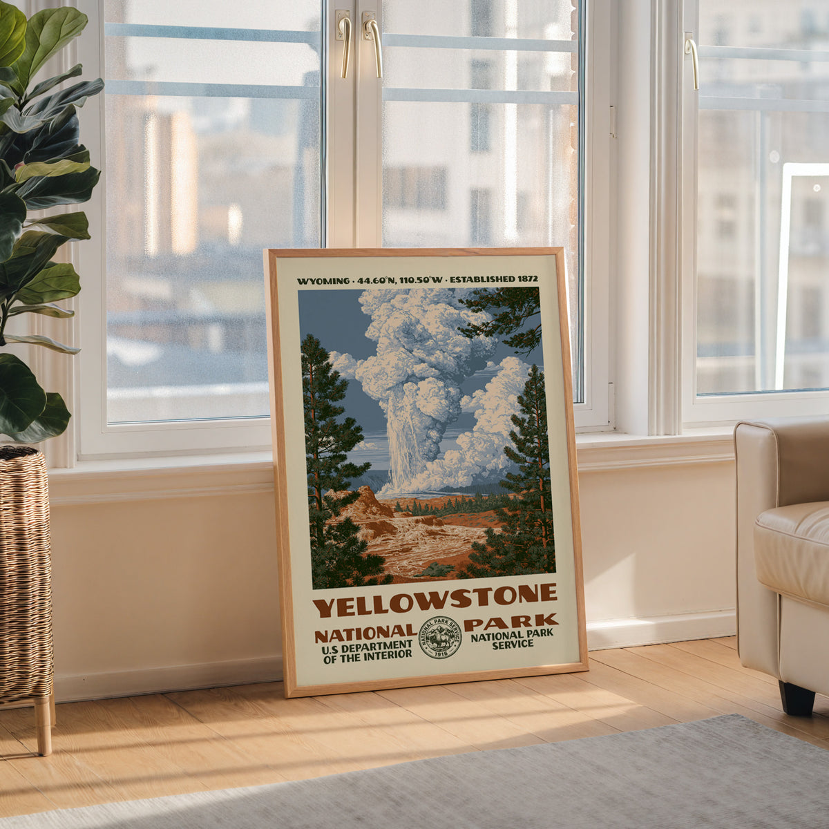 Yellowstone National Park WPA wall art in a wood frame by a tall window with a city skyline view