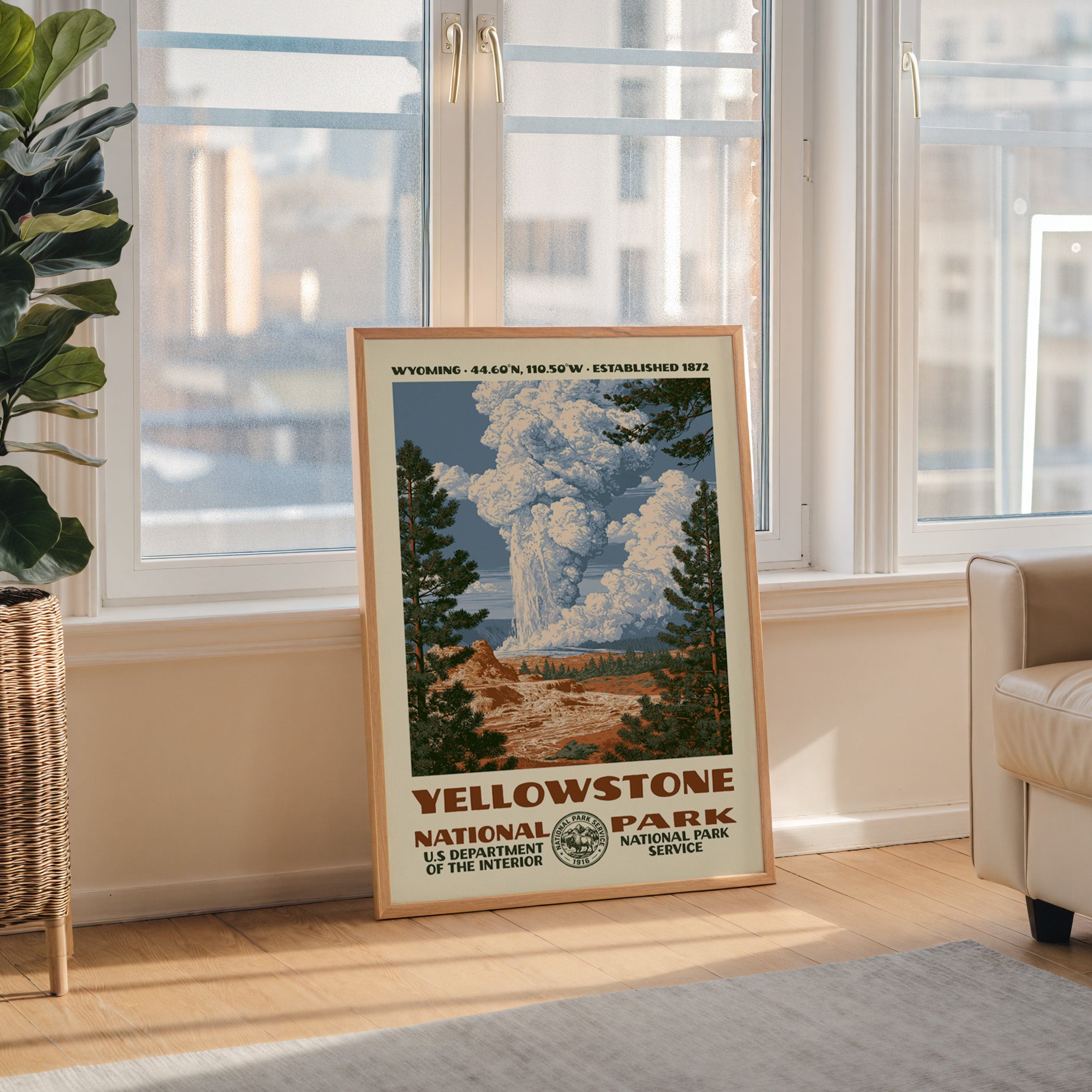 Yellowstone National Park WPA wall art in a wood frame by a tall window with a city skyline view