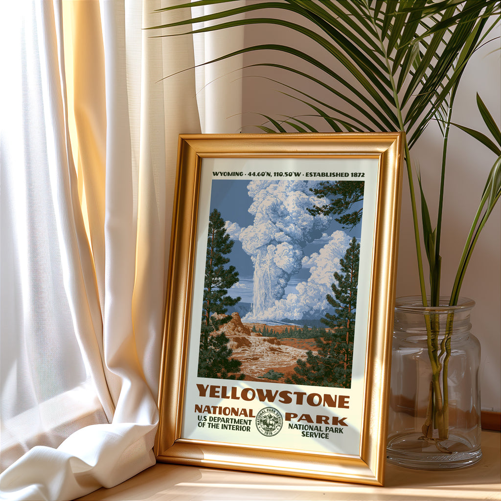 Yellowstone National Park vintage poster in a gold frame beside a linen curtain and potted palm