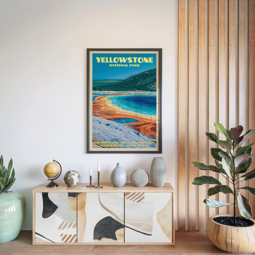 Yellowstone National Park poster in a black frame above a light wood sideboard beside a slatted wall panel