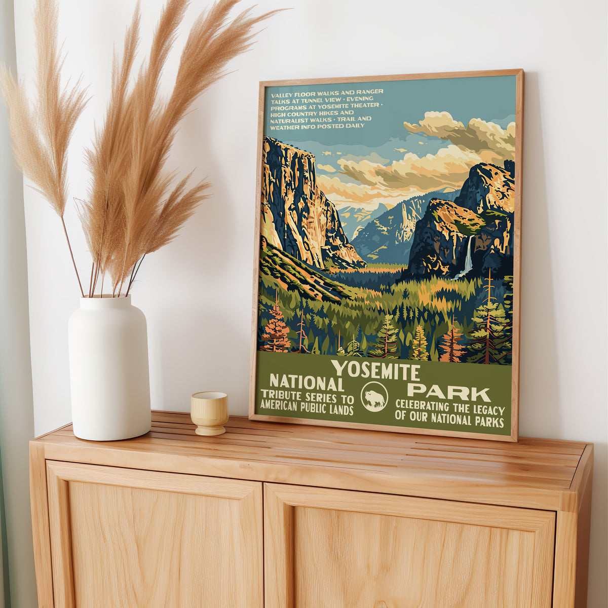 Yosemite National Park wall art leaning on an oak sideboard with pampas grass in a vase