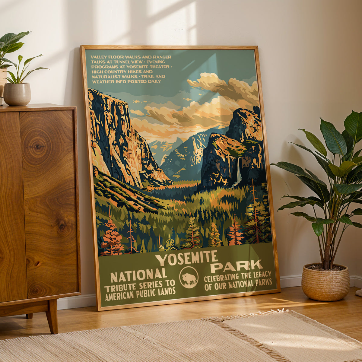 Yosemite National Park WPA print framed on a wood floor beside a cabinet and potted plant
