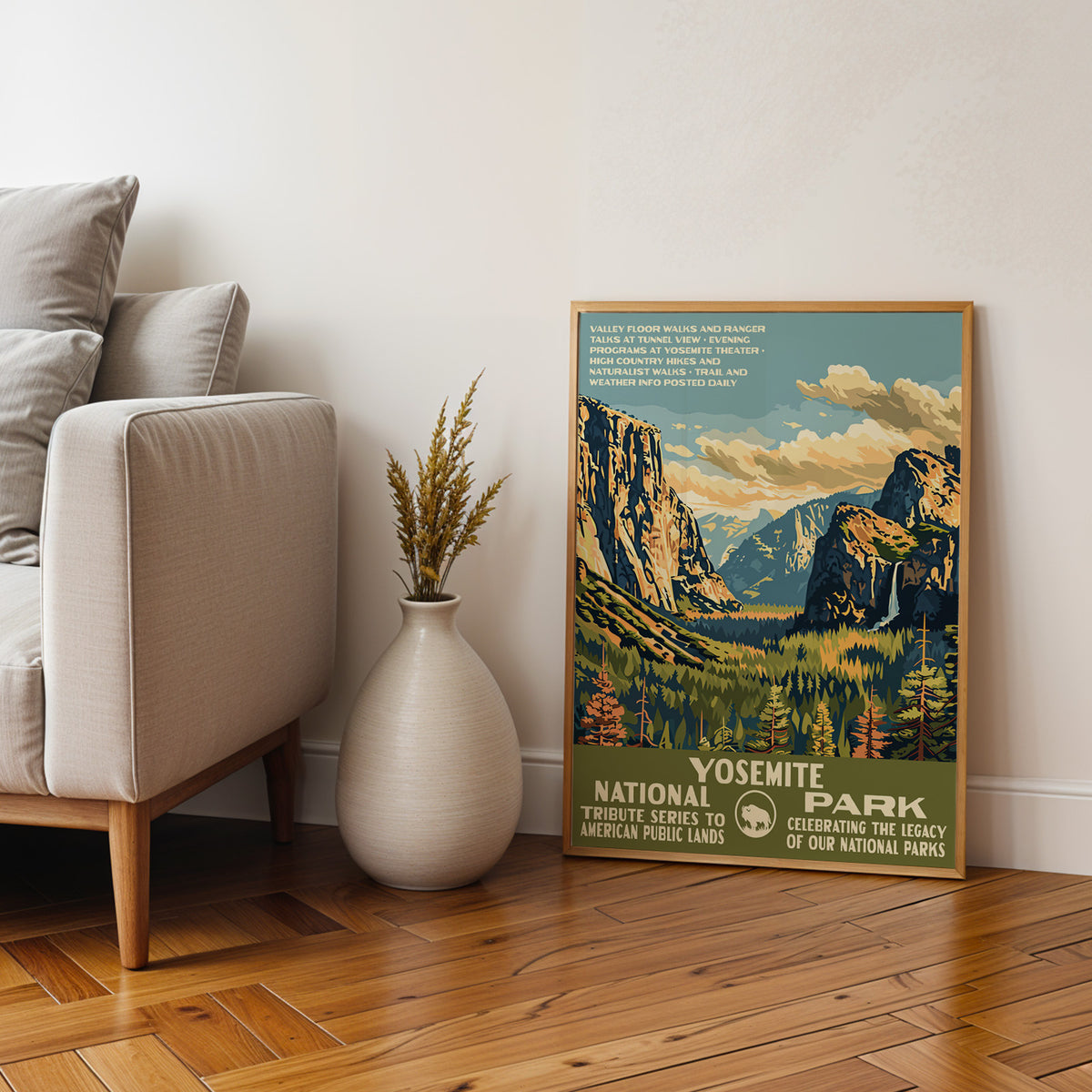 Yosemite National Park framed print on parquet beside an armchair and a tall stone vase