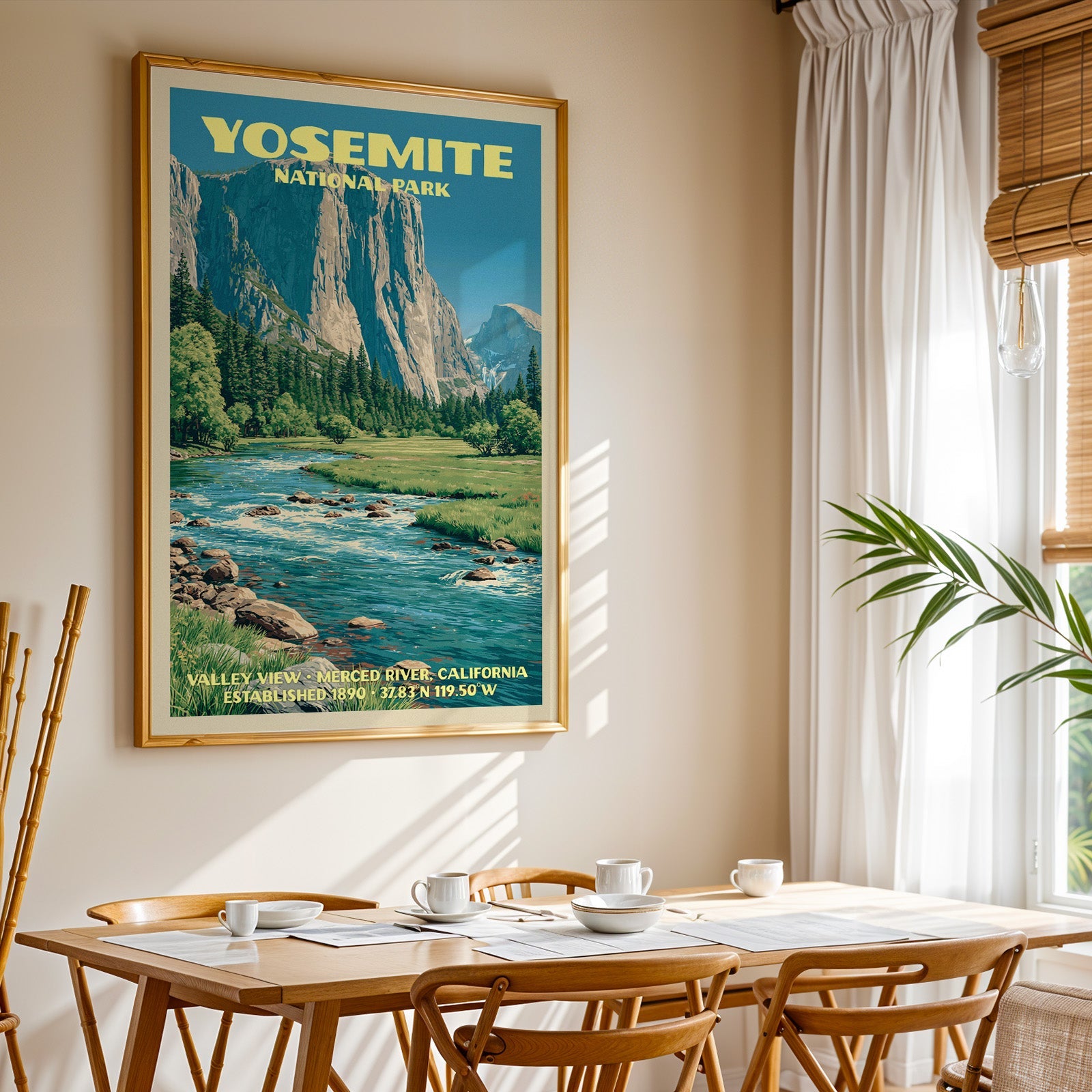 Yosemite National Park print in gold above a light oak dining table by a sheer-curtained window