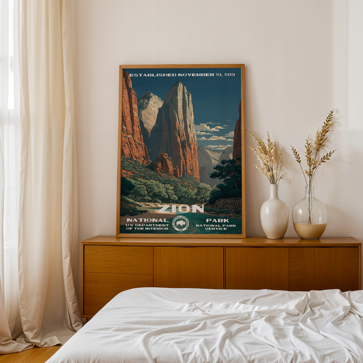 Zion National Park retro poster above a walnut sideboard in a bright linen bedroom