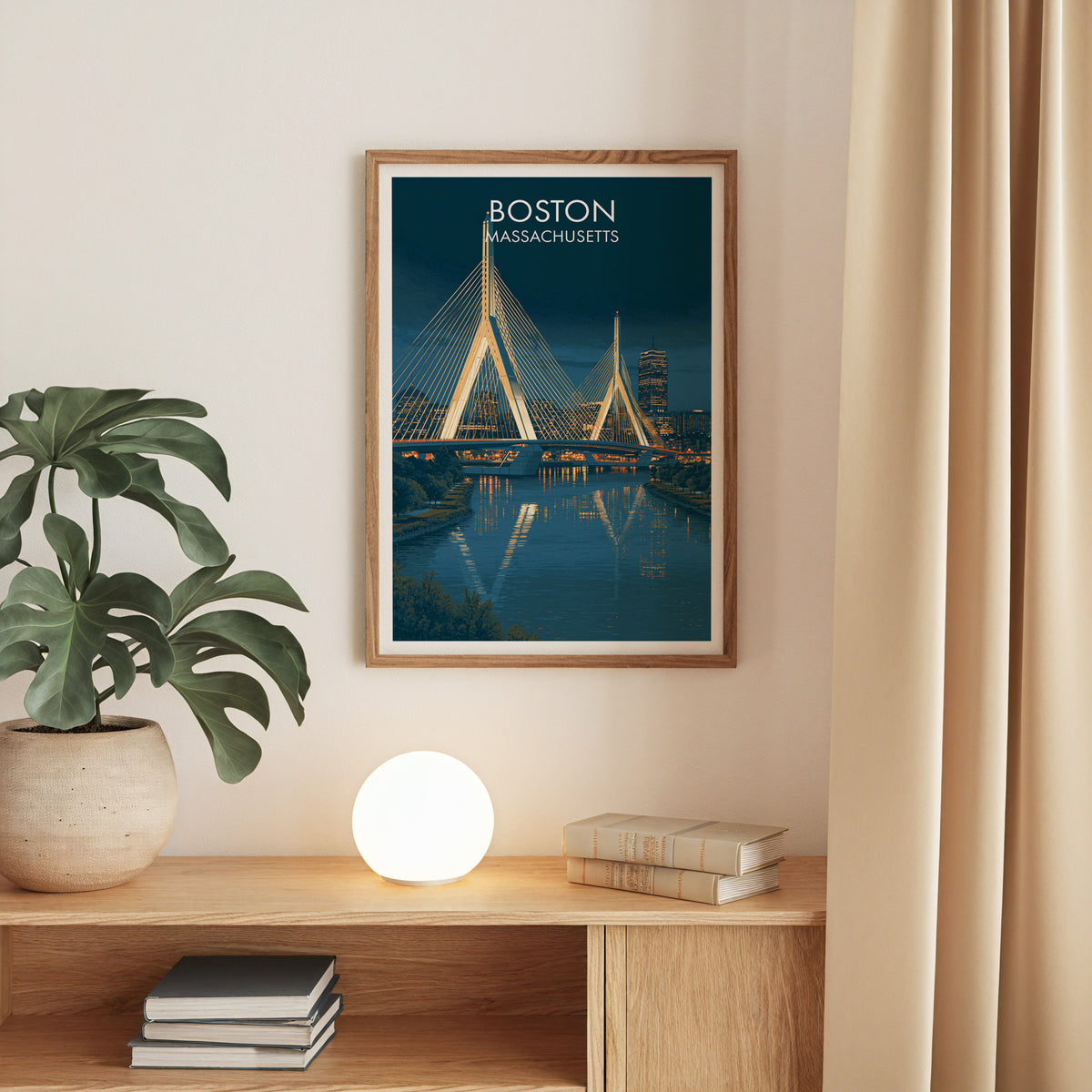Oak-framed Zakim Bridge canvas print on a beige wall above an oak console with monstera and globe lamp.