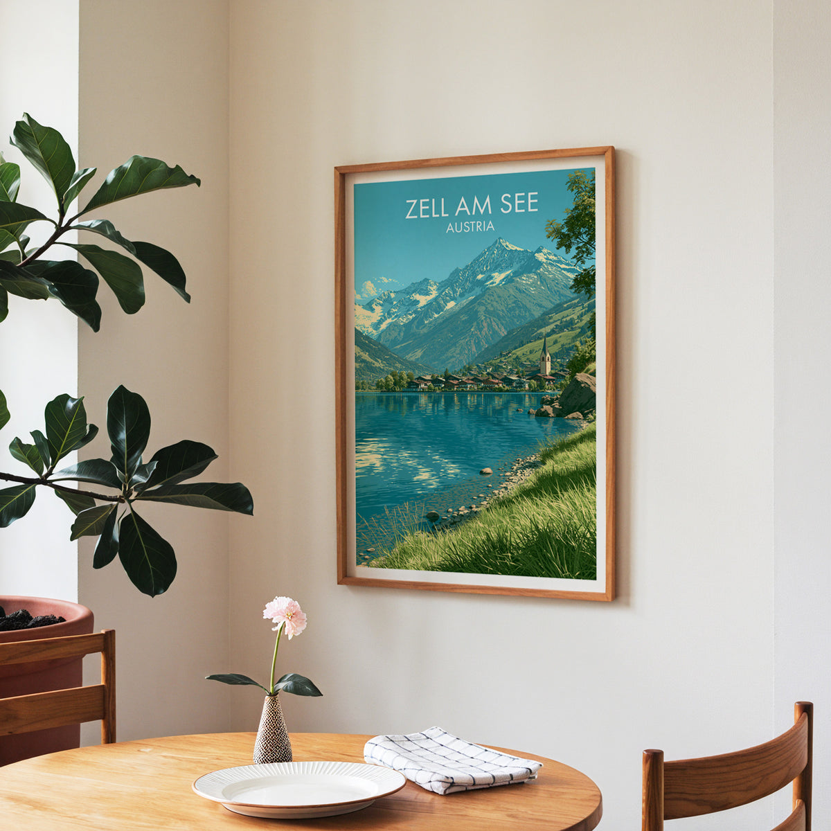 Zell am See alpine poster, walnut frame in a dining corner above a round table and a fiddle-leaf fig