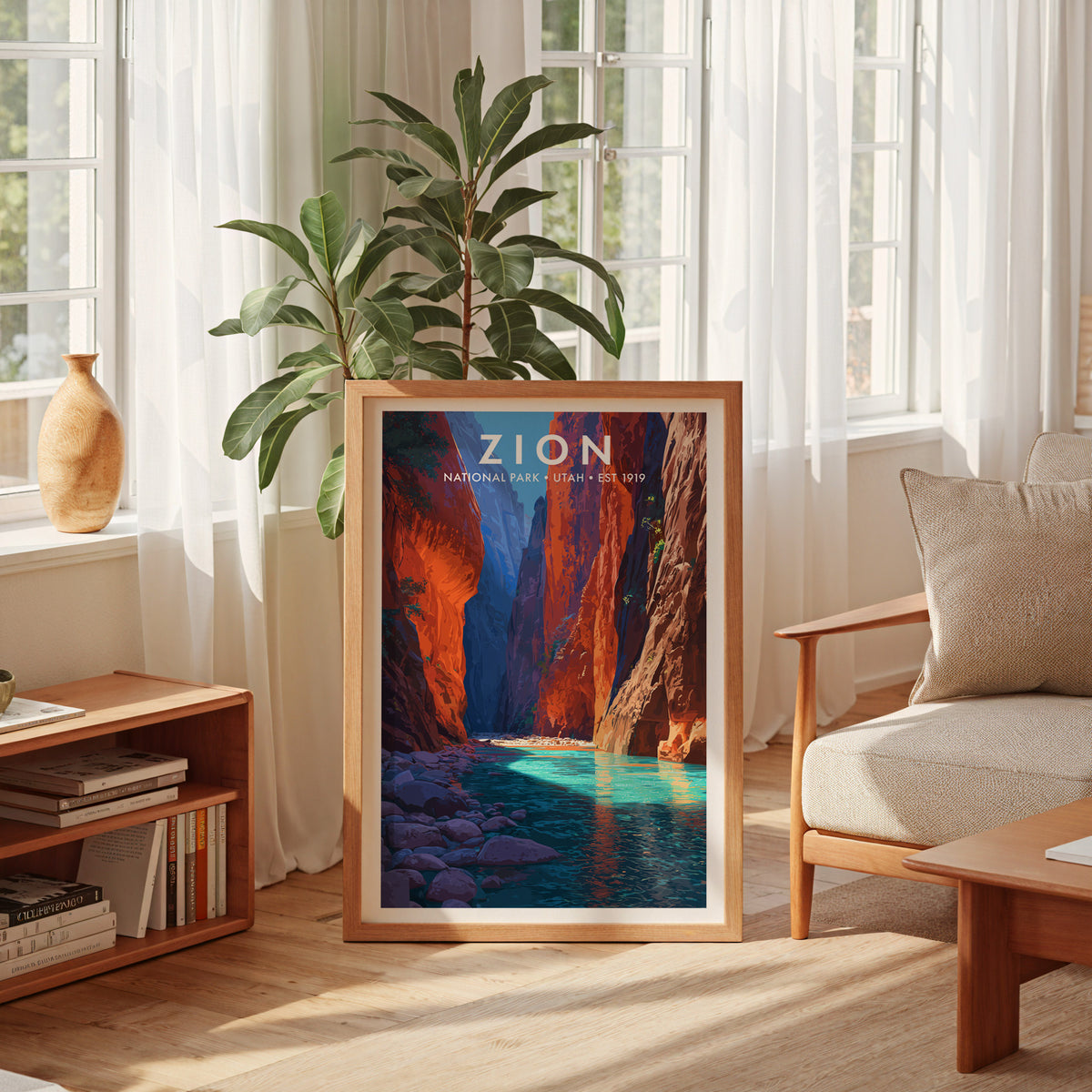 Zion National Park mid-century modern art print framed and leaning against the wall of a sun-filled living room beside an armchair and houseplant — living room wall art