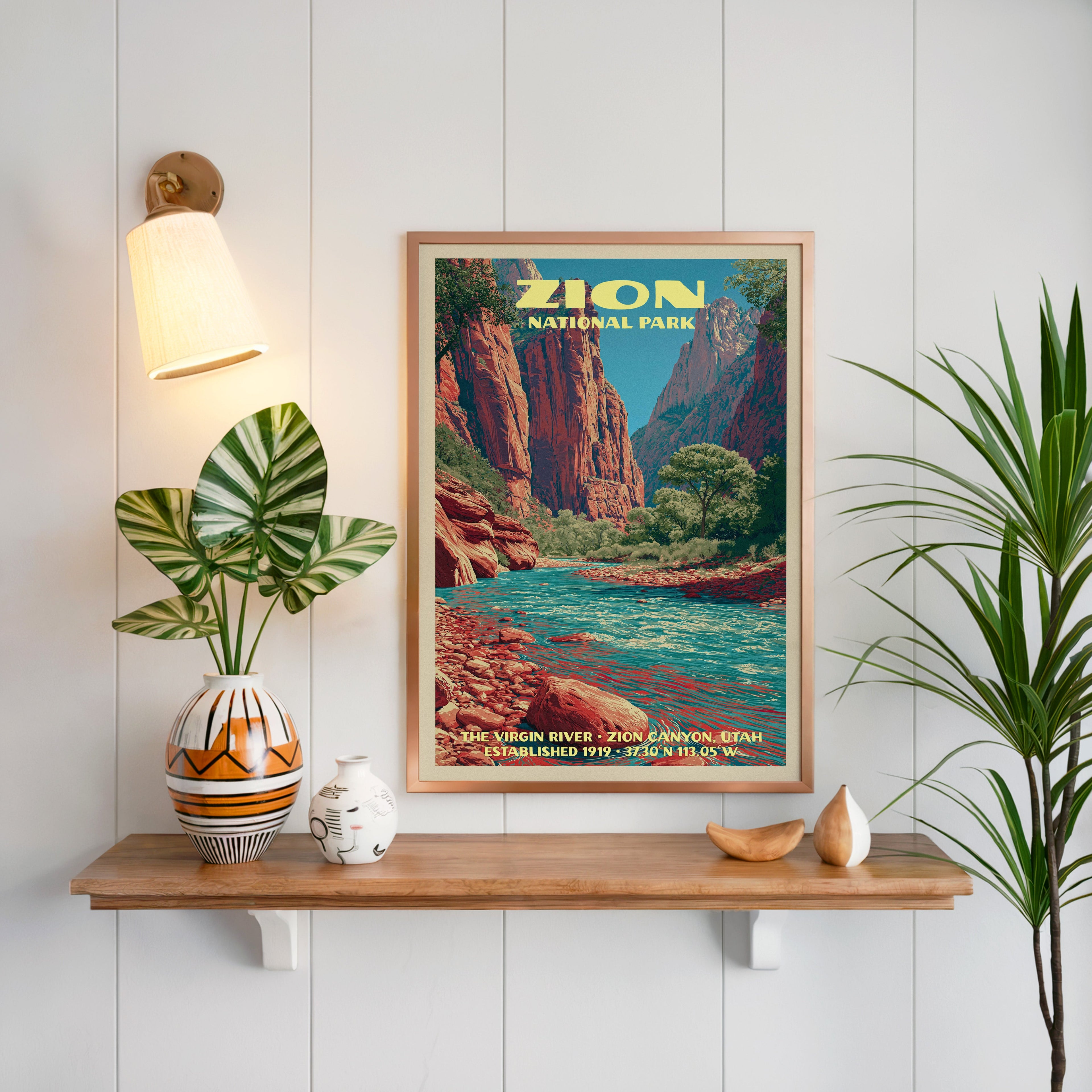 Virgin River print framed in oak on white panelling above a floating shelf with a patterned vase and sconce