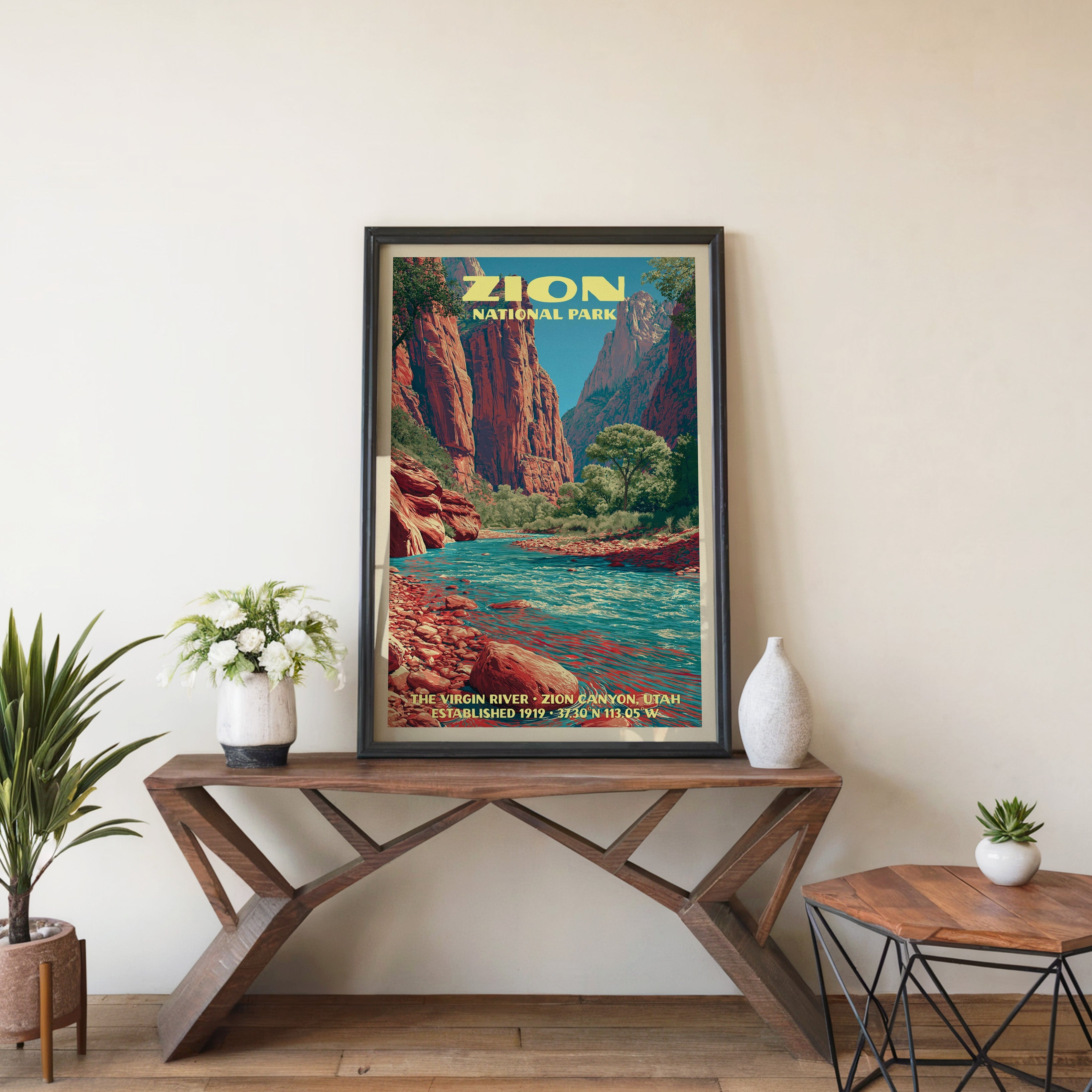 Virgin River wall art in black, leaning on a walnut console with white anemones and a small ceramic vase