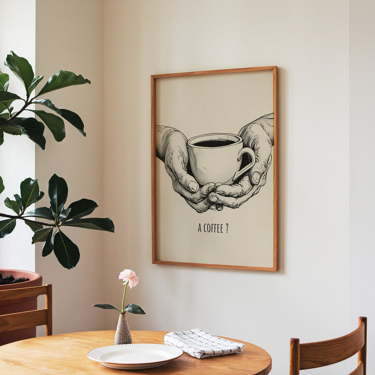 A Coffee sketch print in a walnut frame above a round table beside a fiddle-leaf fig