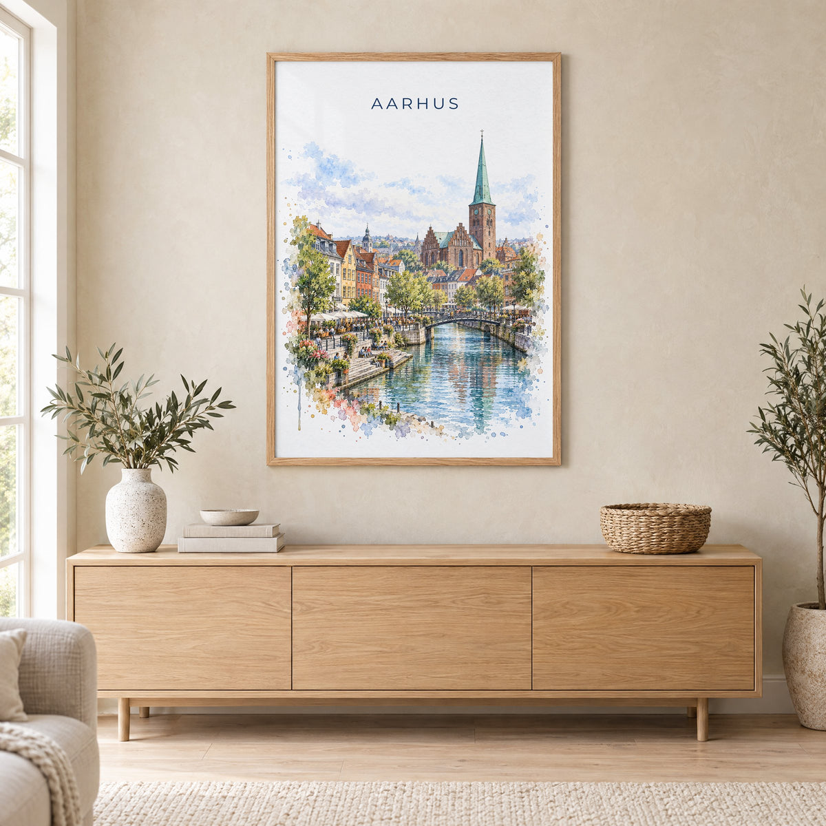 Aarhus watercolor print in an oak frame above a light wood sideboard in a Scandinavian living room