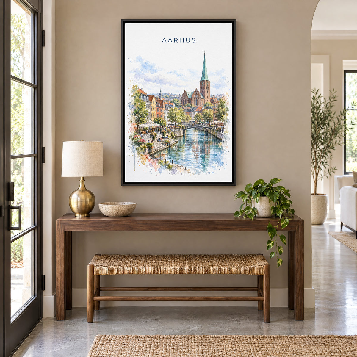 Aarhus watercolor print as a black floater canvas above a walnut console and woven bench in an entryway