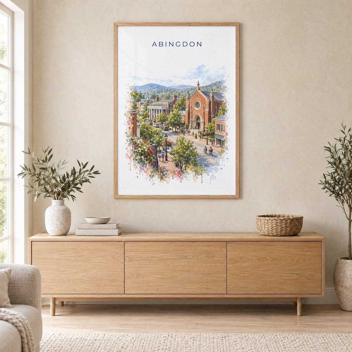 Abingdon, Virginia watercolor print in an oak frame above a light wood sideboard in a Scandinavian living room