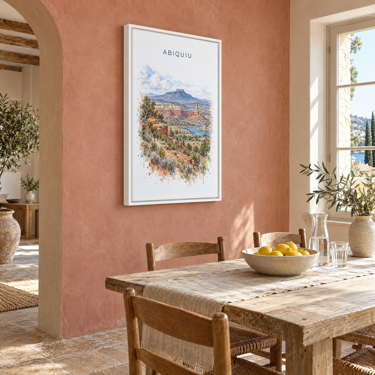 Abiquiu, New Mexico watercolor print as a white floater canvas on a terracotta wall above a rustic dining table