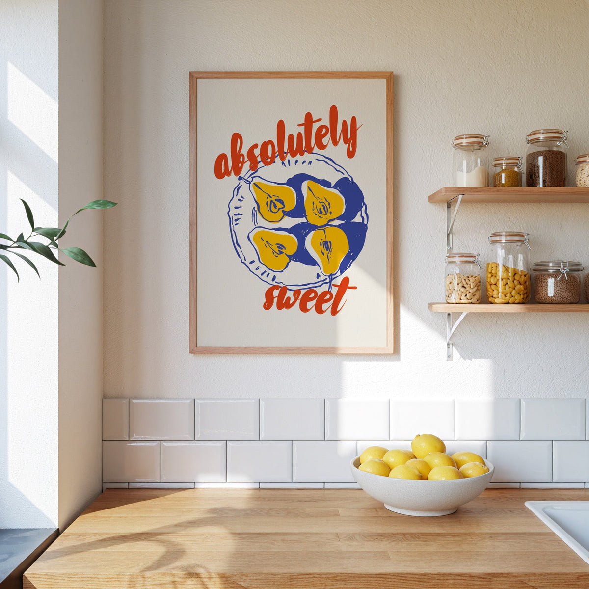 Absolutely Sweet pears print in an oak frame beside open kitchen shelves
