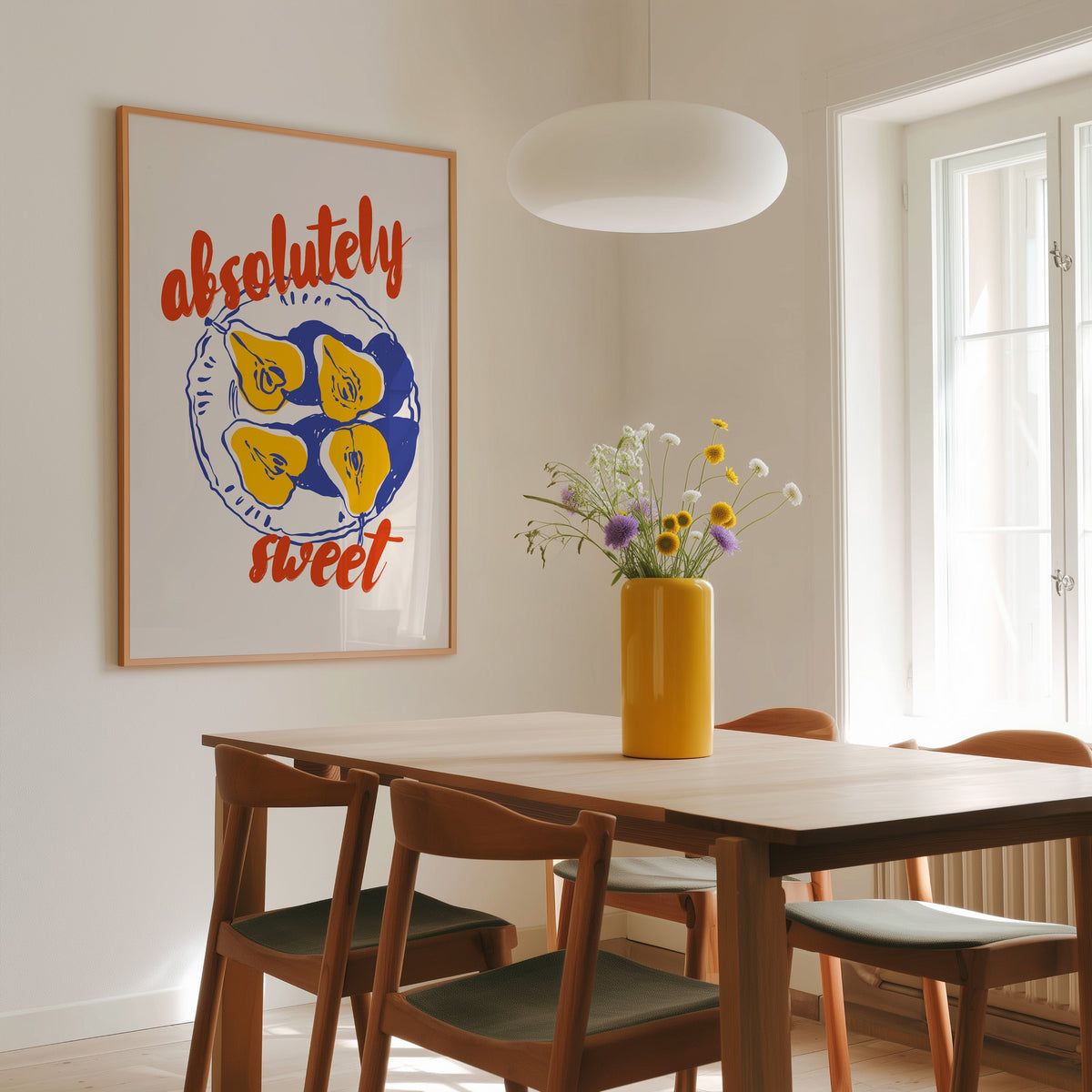 Absolutely Sweet pears print in a slim oak frame above a dining table