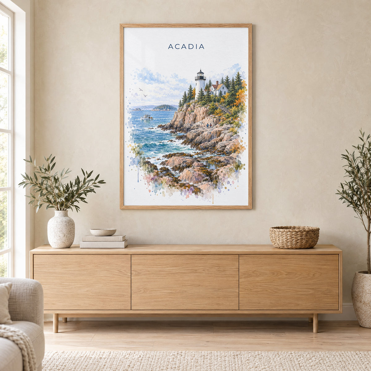 Acadia National Park watercolor print in an oak frame above a light wood sideboard in a Scandinavian living room