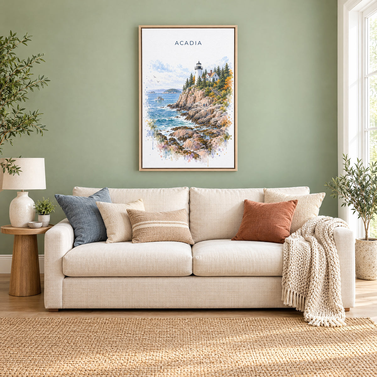 Acadia National Park watercolor print as a natural floater canvas above a cream linen sofa on a sage green wall