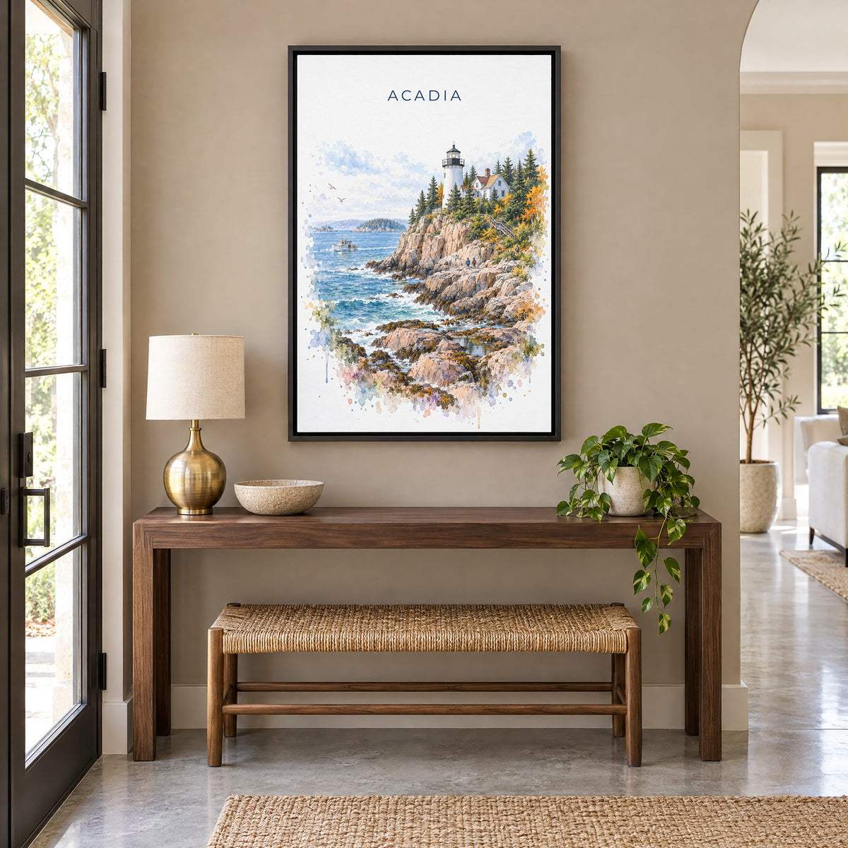 Acadia National Park watercolor print as a black floater canvas above a walnut console and woven bench in an entryway