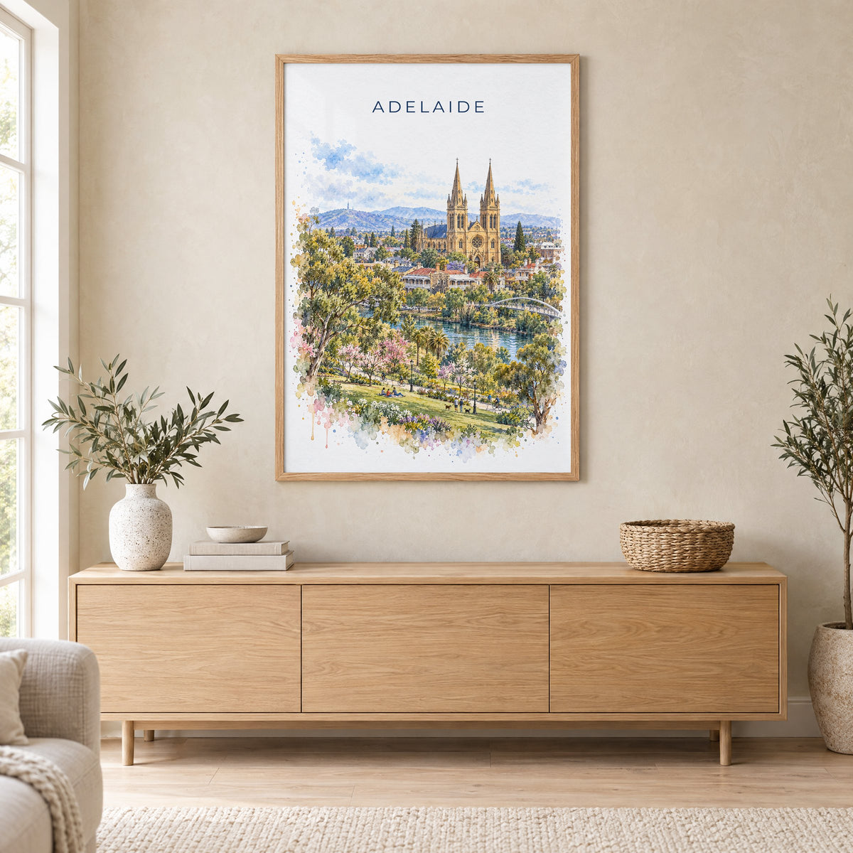 Adelaide watercolor print in an oak frame above a light wood sideboard in a Scandinavian living room