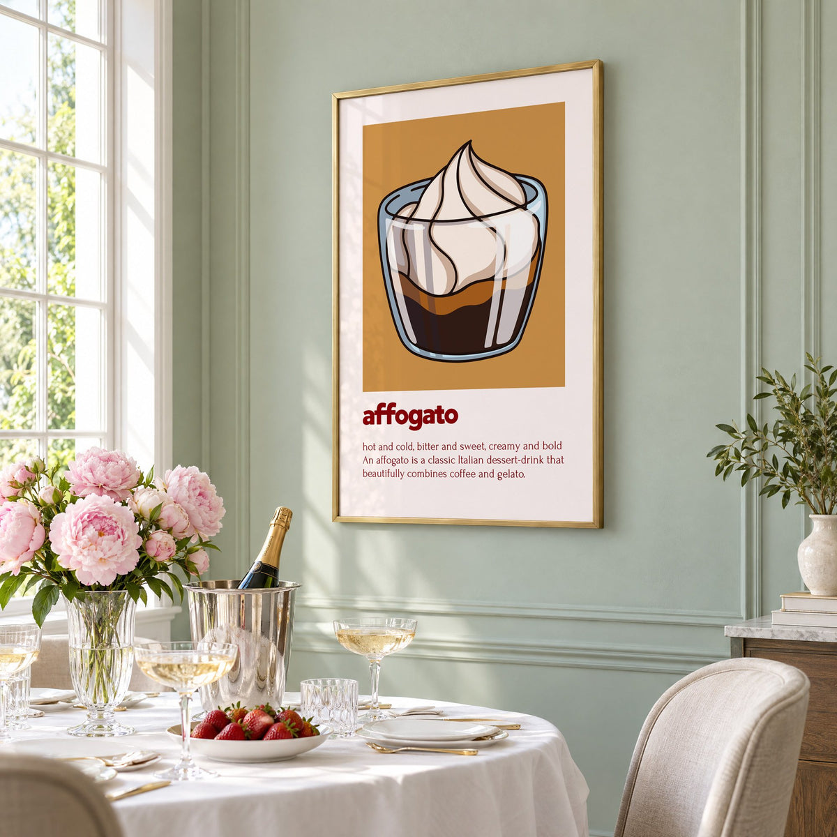affogato gelato and coffee ochre card print in a brass frame on a sage wall above a brunch table with champagne and peonies, seen at an angle