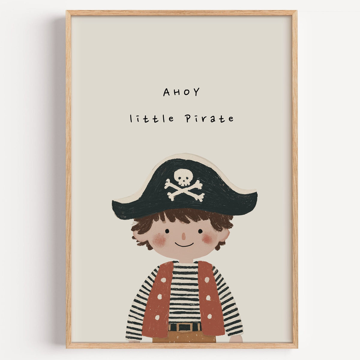 Ahoy little pirate boy nursery print in a light oak frame on a plain white wall