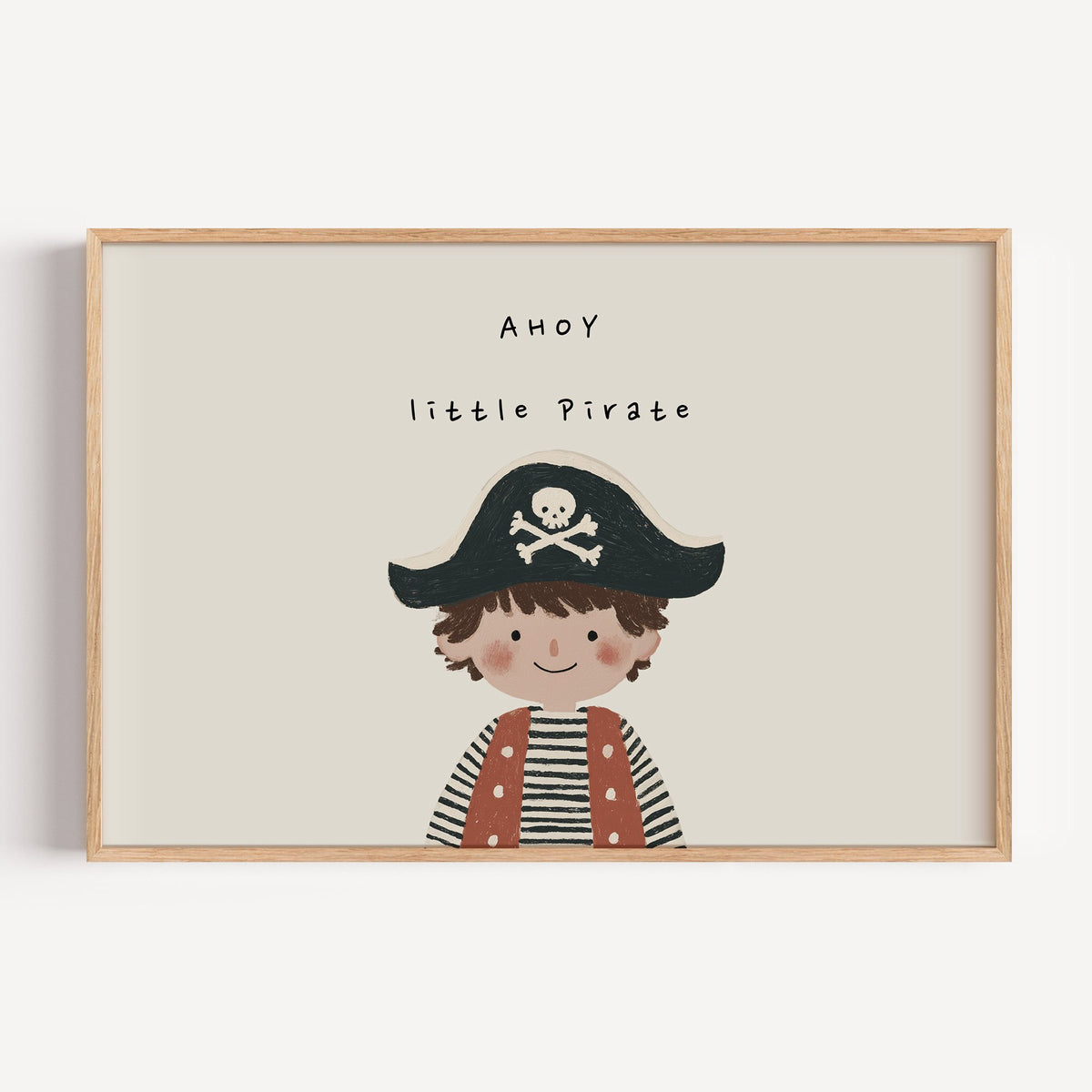 Landscape ahoy little pirate boy nursery print in a light oak frame on a plain white wall