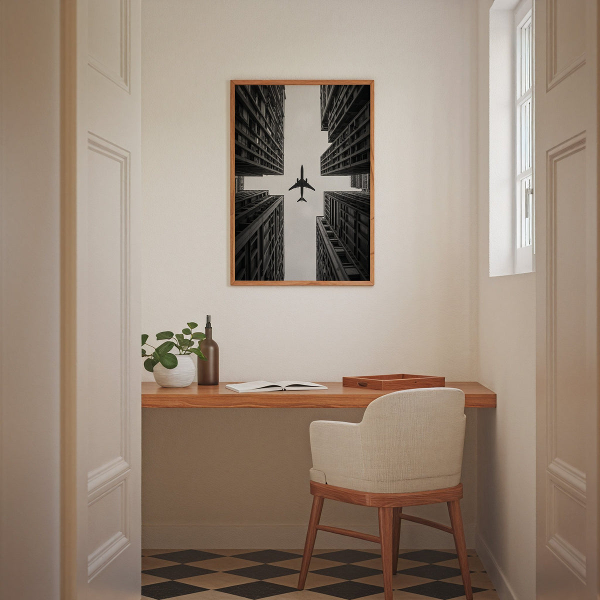 Airplane flying between four skyscrapers print in an oak frame above a home office desk nook