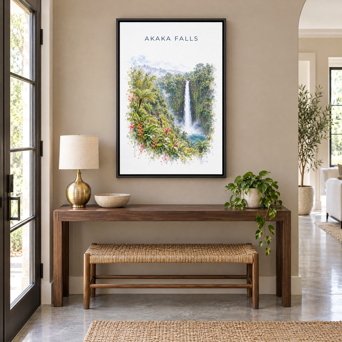 Akaka Falls watercolor print as a black floater canvas above a walnut console and woven bench in an entryway
