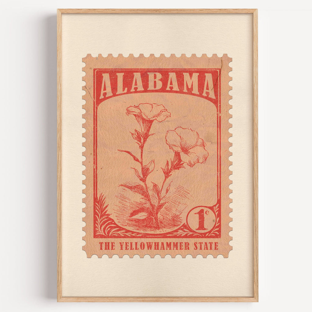 Alabama state flower stamp print in brick red on peach, light oak frame on a plain white wall