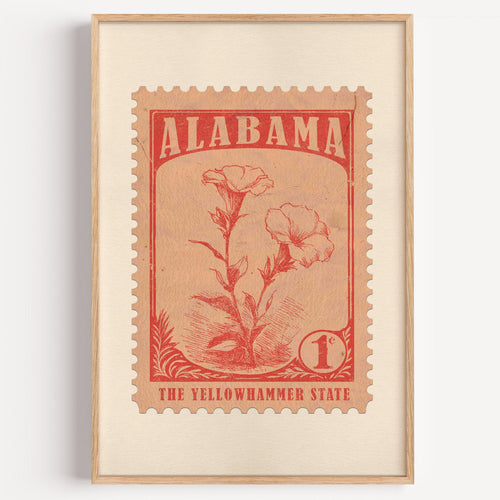 Alabama state flower stamp print in brick red on peach, light oak frame on a plain white wall