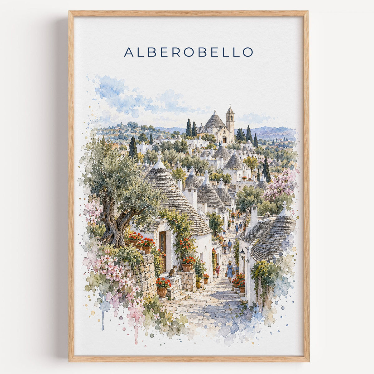 Alberobello watercolor print in a light oak frame on a plain white wall