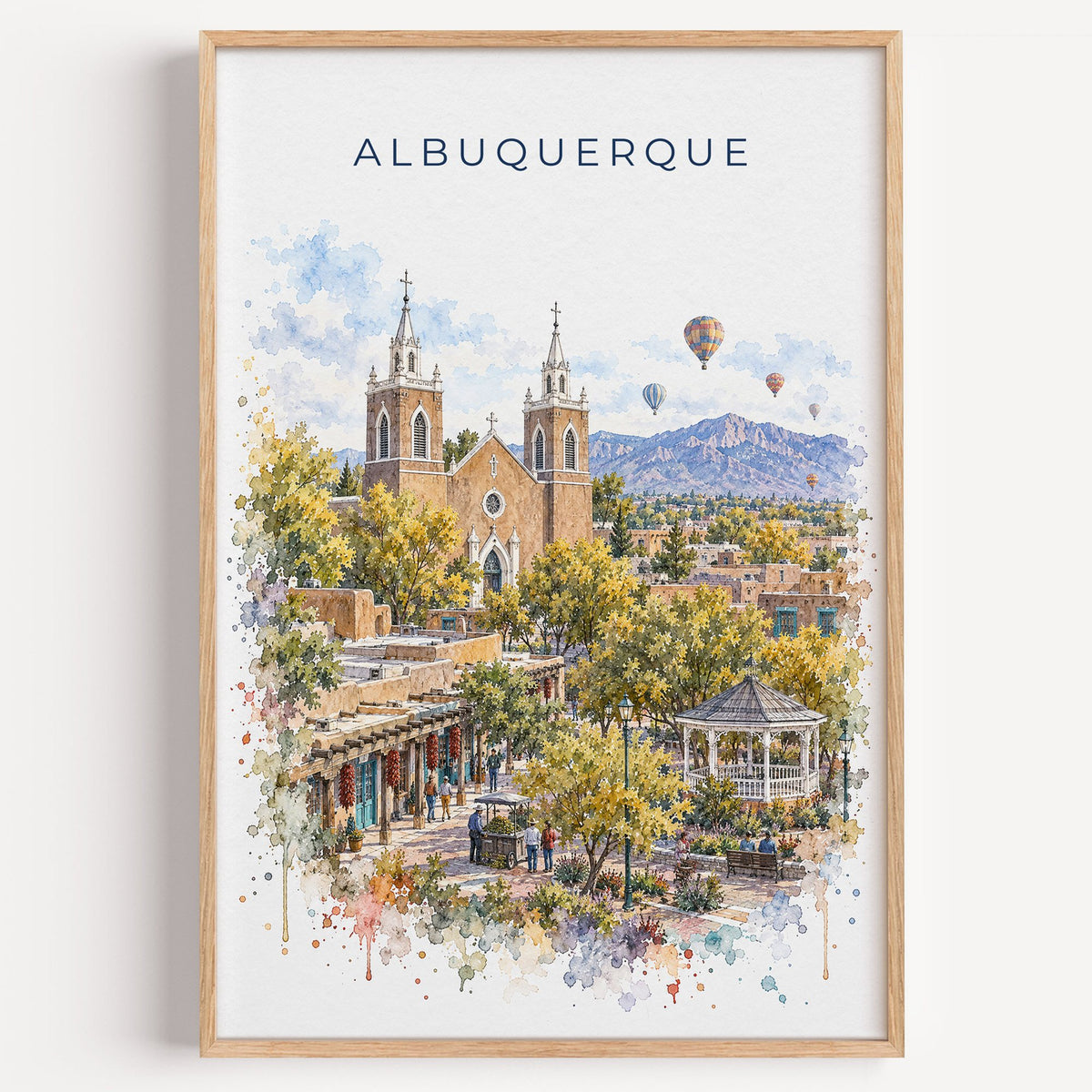 Albuquerque watercolor print in a light oak frame on a plain white wall