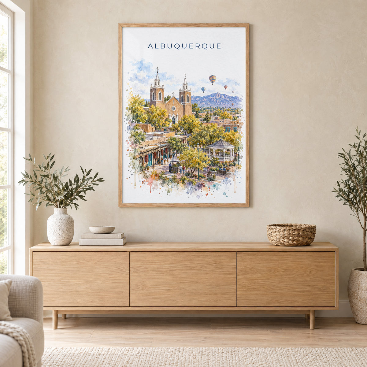 Albuquerque watercolor print in an oak frame above a light wood sideboard in a Scandinavian living room