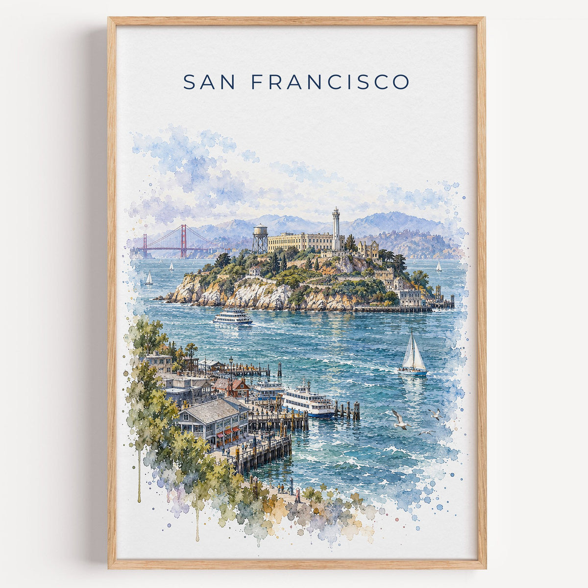 Alcatraz Island watercolor print in a light oak frame on a plain white wall