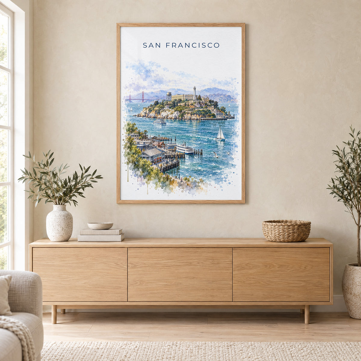 Alcatraz Island watercolor print in an oak frame above a light wood sideboard in a Scandinavian living room