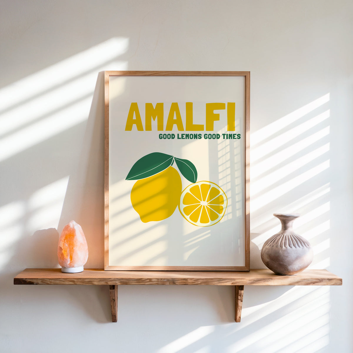 Amalfi lemon print in an oak frame on a live-edge shelf beside a salt lamp