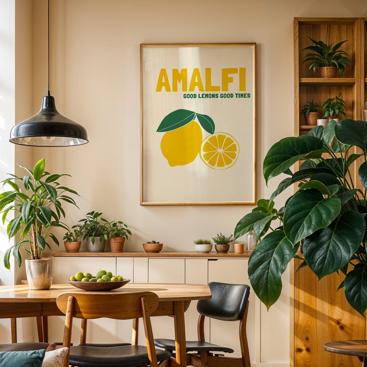 Amalfi lemon print in an oak frame in a dining room above a plant-lined sideboard