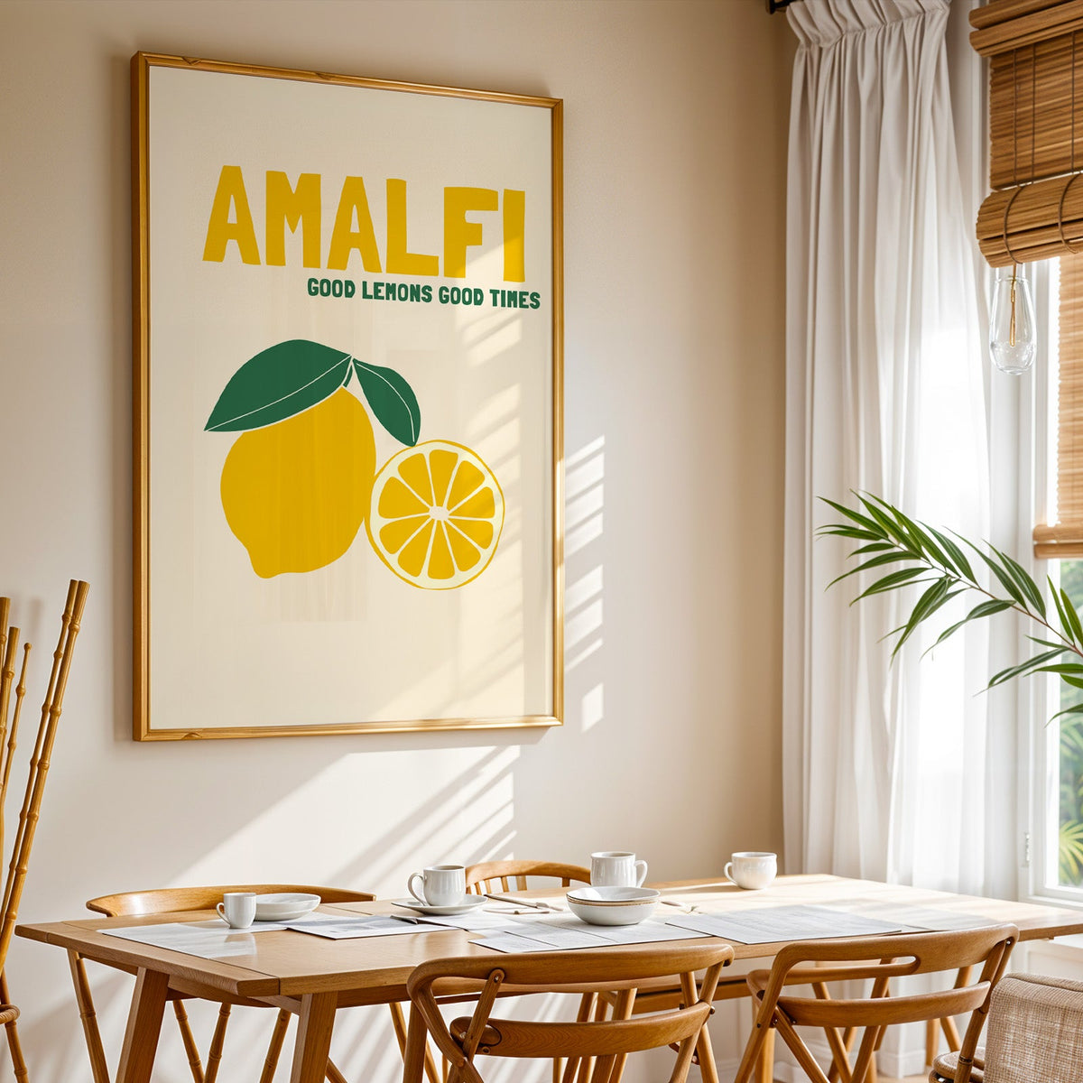 Amalfi lemon print shown in a gold frame above a breakfast table by a curtained window