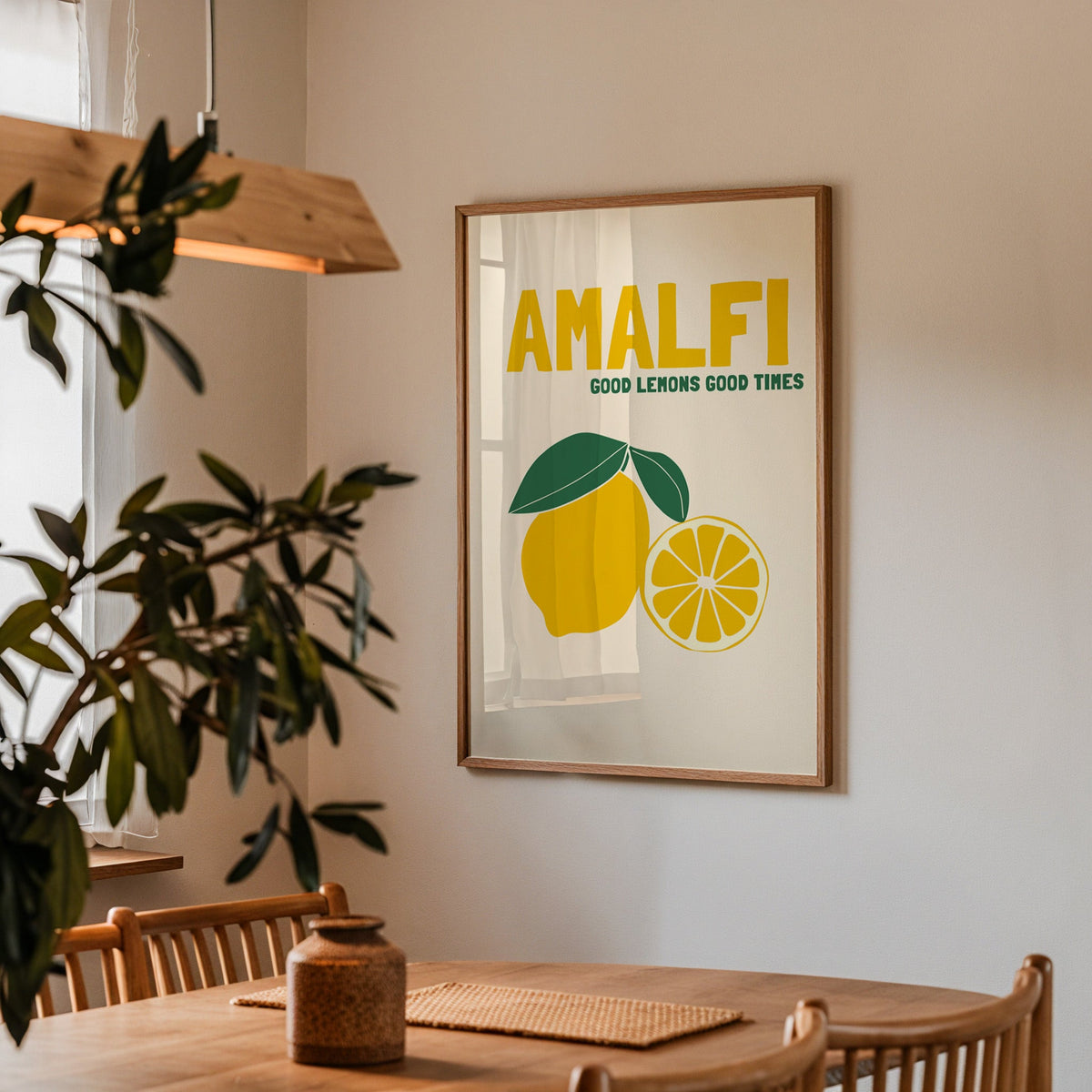Amalfi lemon print in a walnut frame above a dining table with olive branches