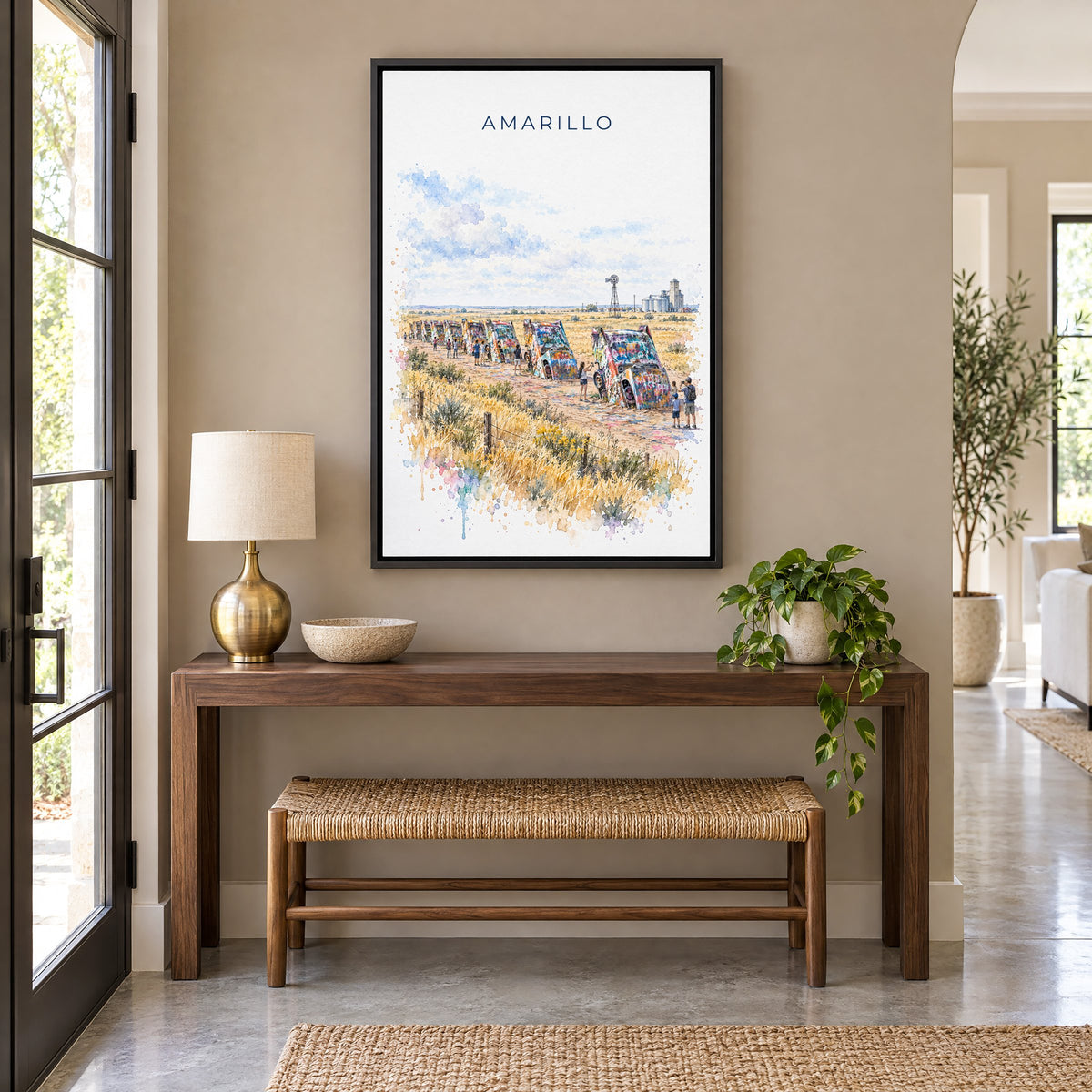 Amarillo watercolor print as a black floater canvas above a walnut console and woven bench in an entryway