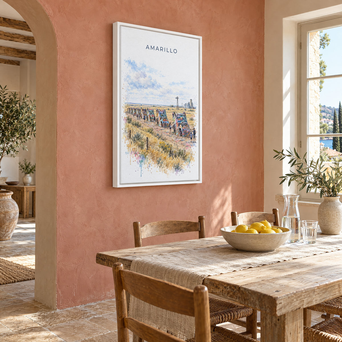 Amarillo watercolor print as a white floater canvas on a terracotta wall above a rustic dining table