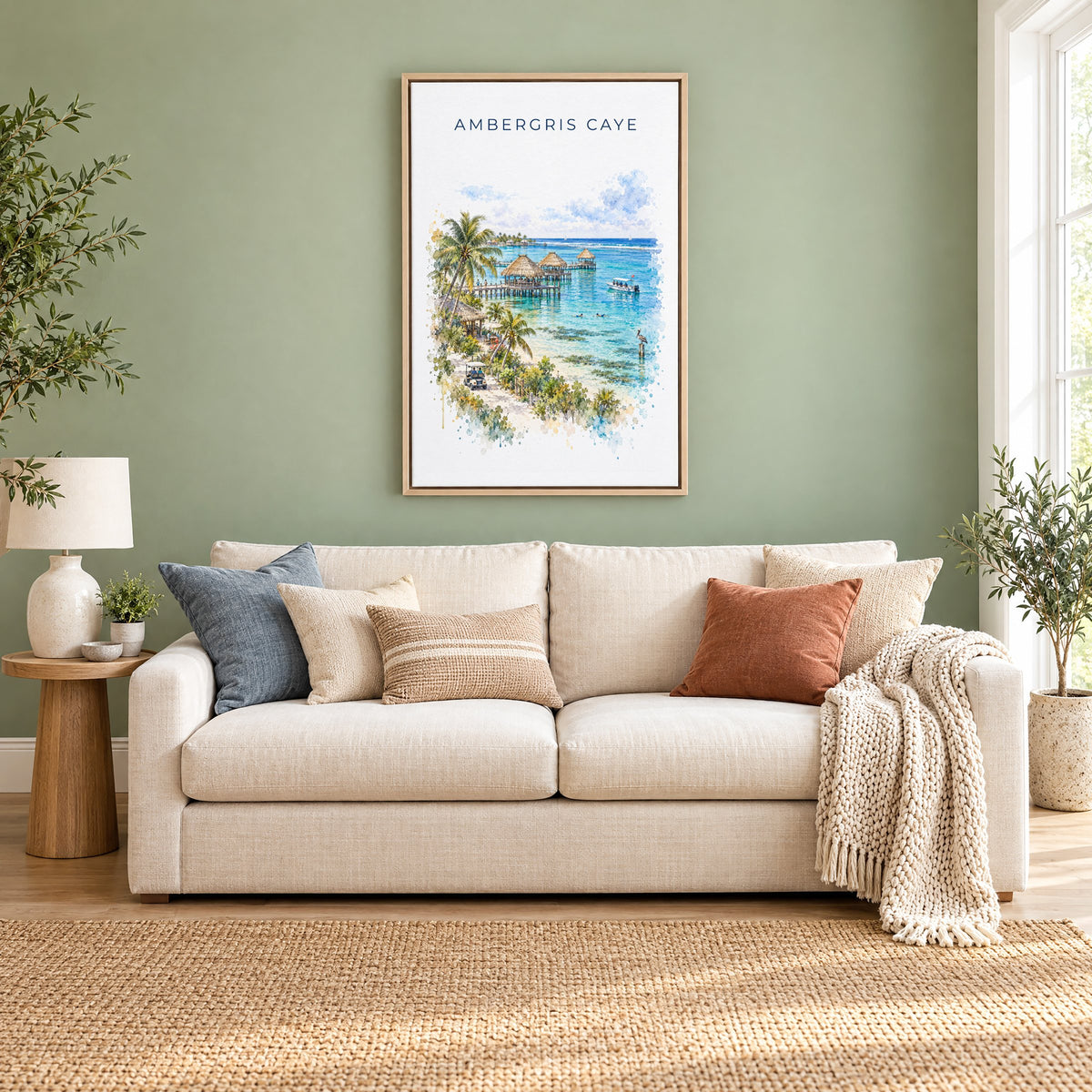 Ambergris Caye watercolor print as a natural floater canvas above a cream linen sofa on a sage green wall