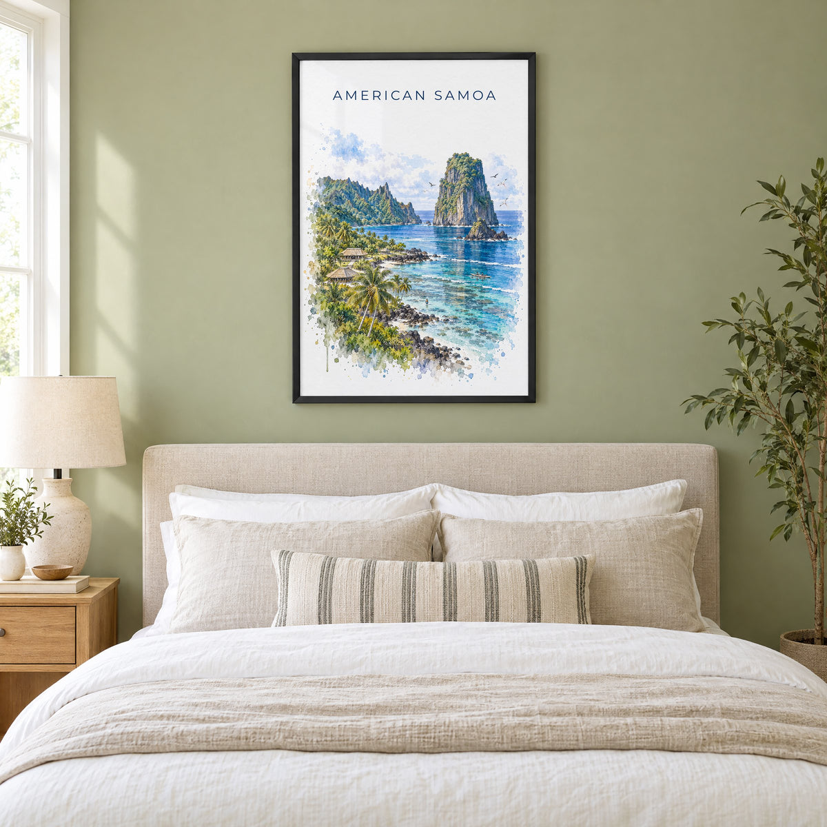 American Samoa National Park watercolor print in a black frame above an upholstered headboard in a sage green bedroom