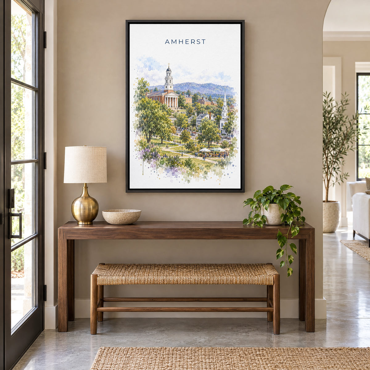 Amherst, Massachusetts watercolor print as a black floater canvas above a walnut console and woven bench in an entryway