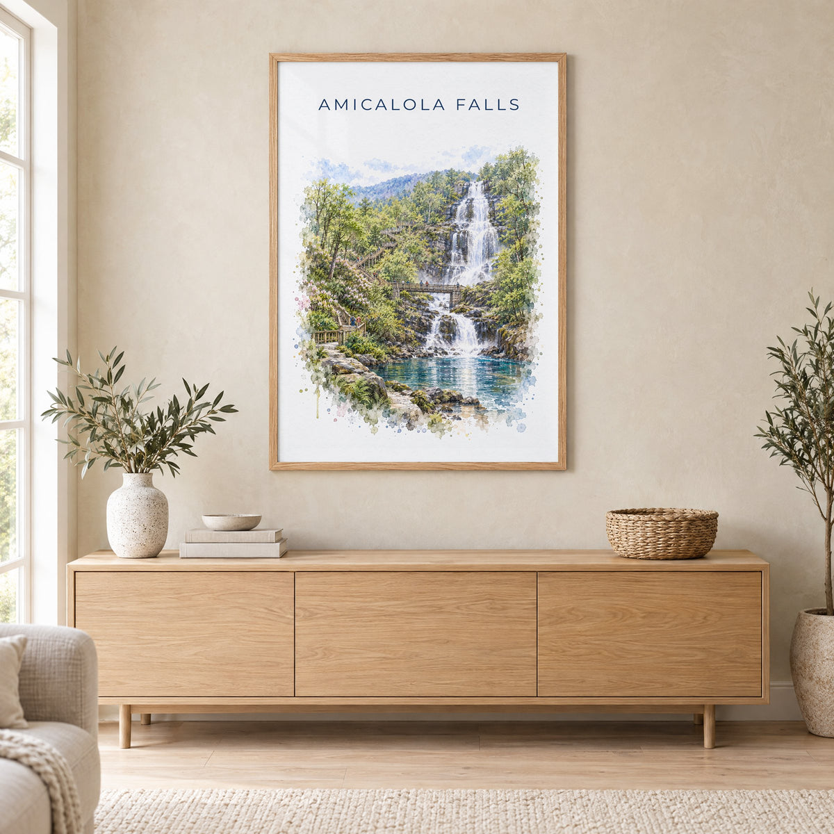 Amicalola Falls State Park watercolor print in an oak frame above a light wood sideboard in a Scandinavian living room