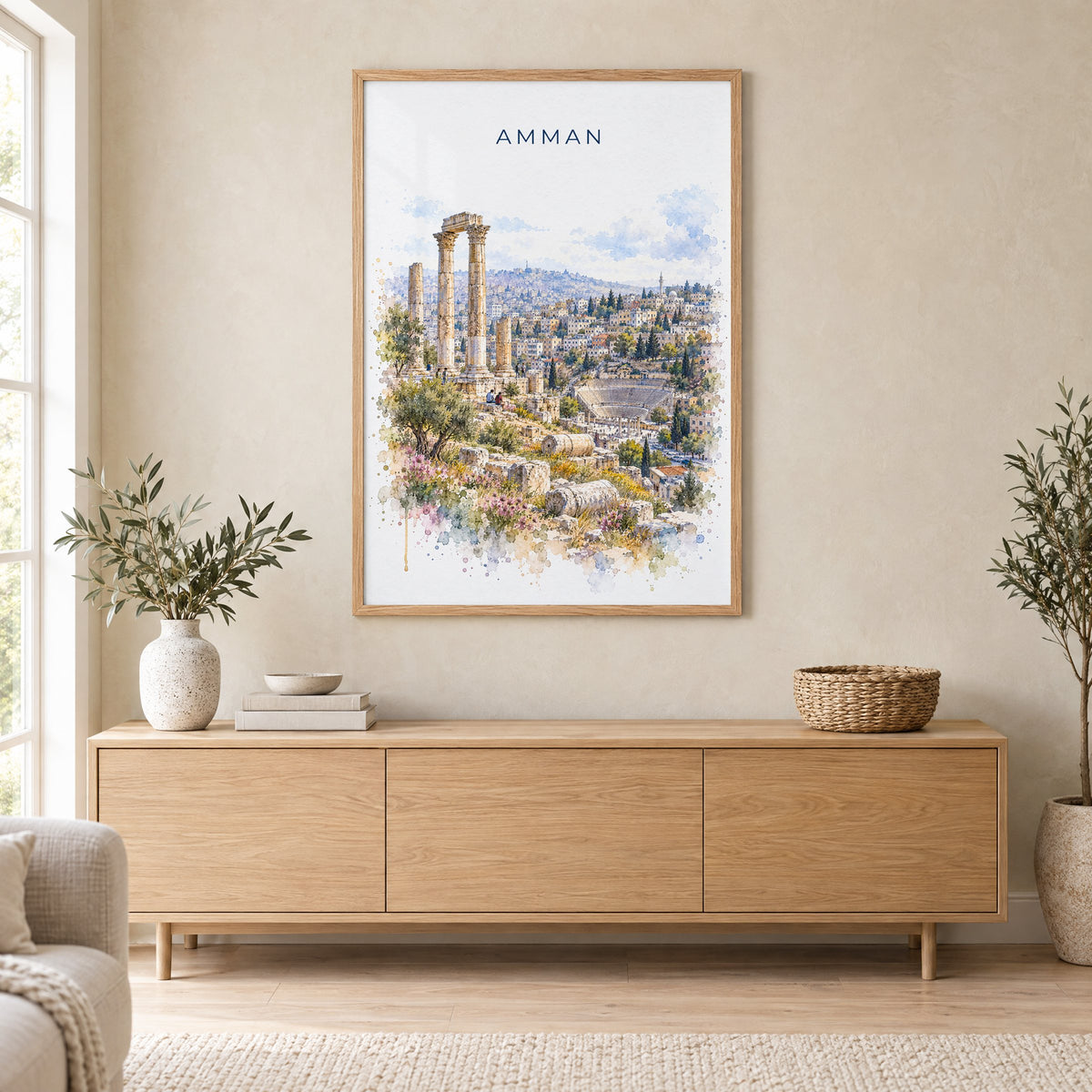 Amman watercolor print in an oak frame above a light wood sideboard in a Scandinavian living room