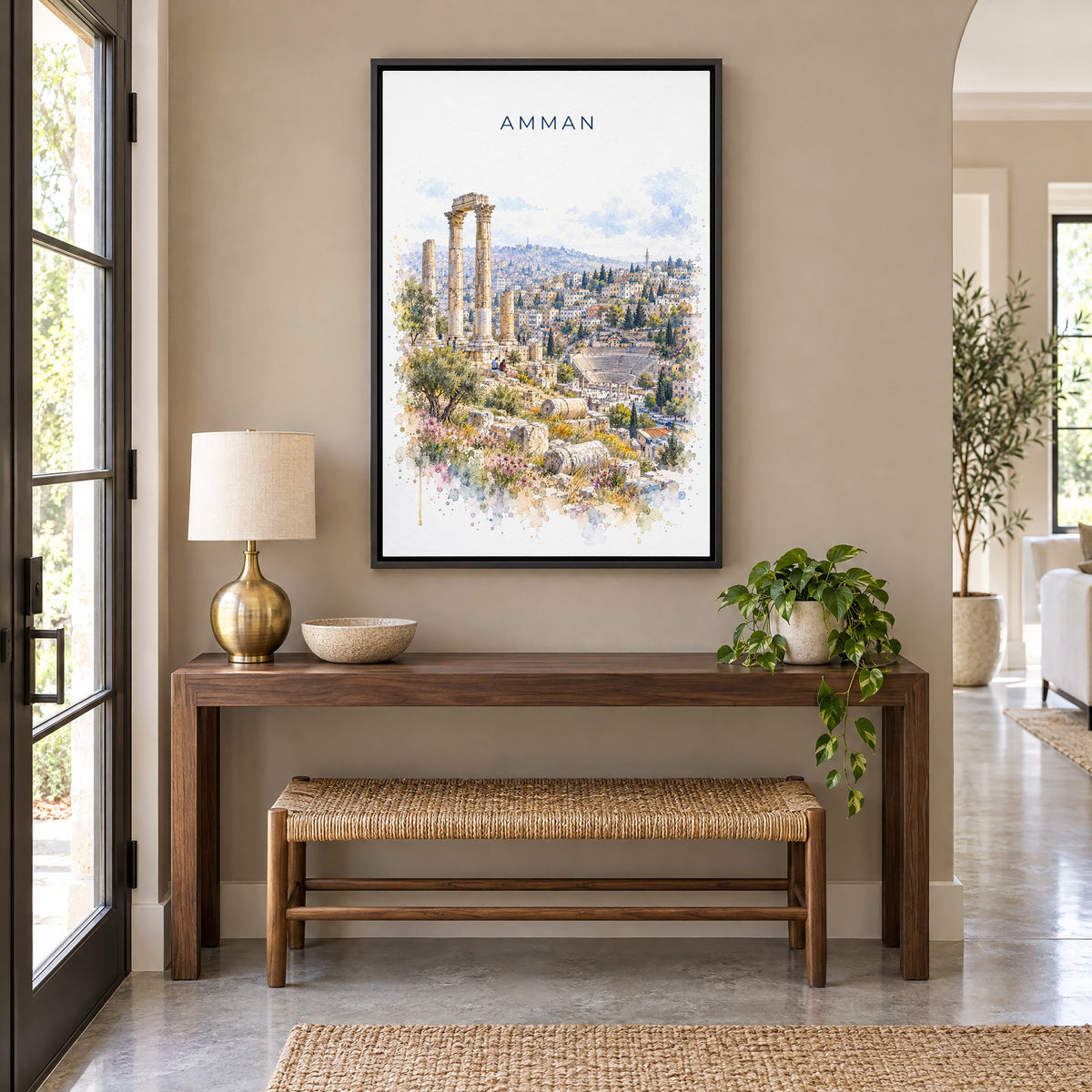 Amman watercolor print as a black floater canvas above a walnut console and woven bench in an entryway